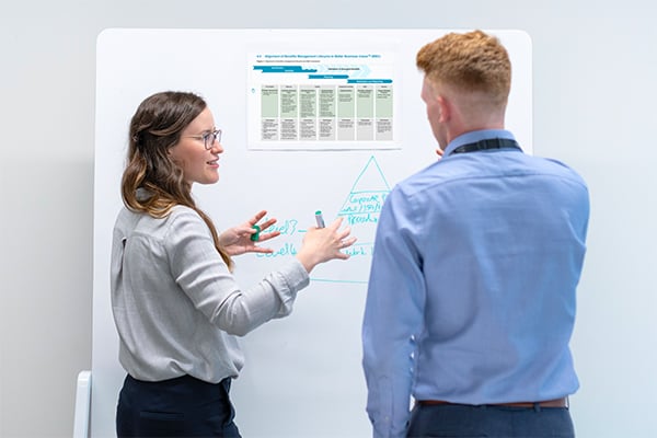 Two public servants discuss a business case.