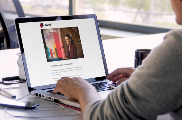Click the photo of a man reading Boost News on a laptop to view the archive.