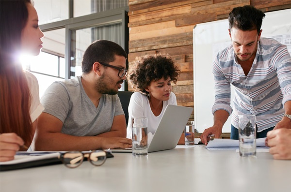 Click the photo of a team discussing an Agile Accelerator assessment to learn more.