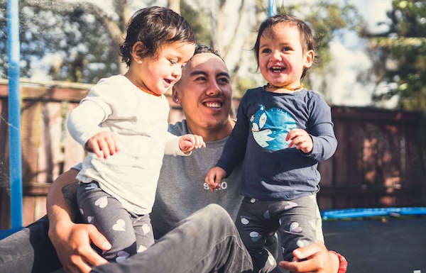 A father having quality time with his kids after FinCap helped him sort out his finances.