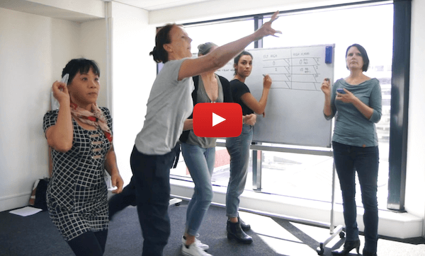 Playing the paper plane game in the Agile Professional Foundation. Click to preview the course on YouTube.