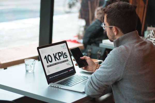Reading Pendo's 10 KPIs Every Product Leader Needs to Know ebook on a laptop.